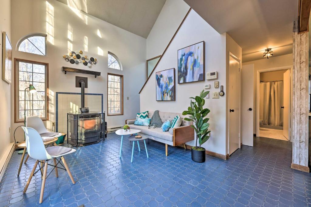 a living room with a couch and a fireplace at Fire Pit, Deck and Pool Access Modern Poconos Gem in Tobyhanna