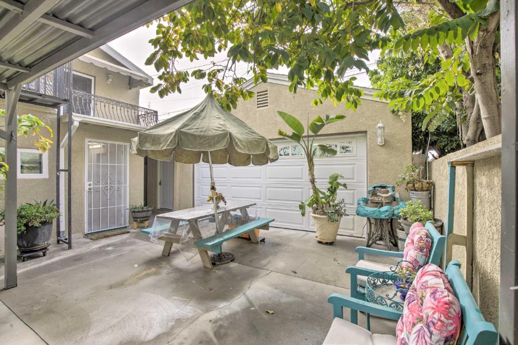 a patio with a table and chairs and an umbrella at Westminster Studio with Patio Less Than 9 Mi to Beach! in Westminster