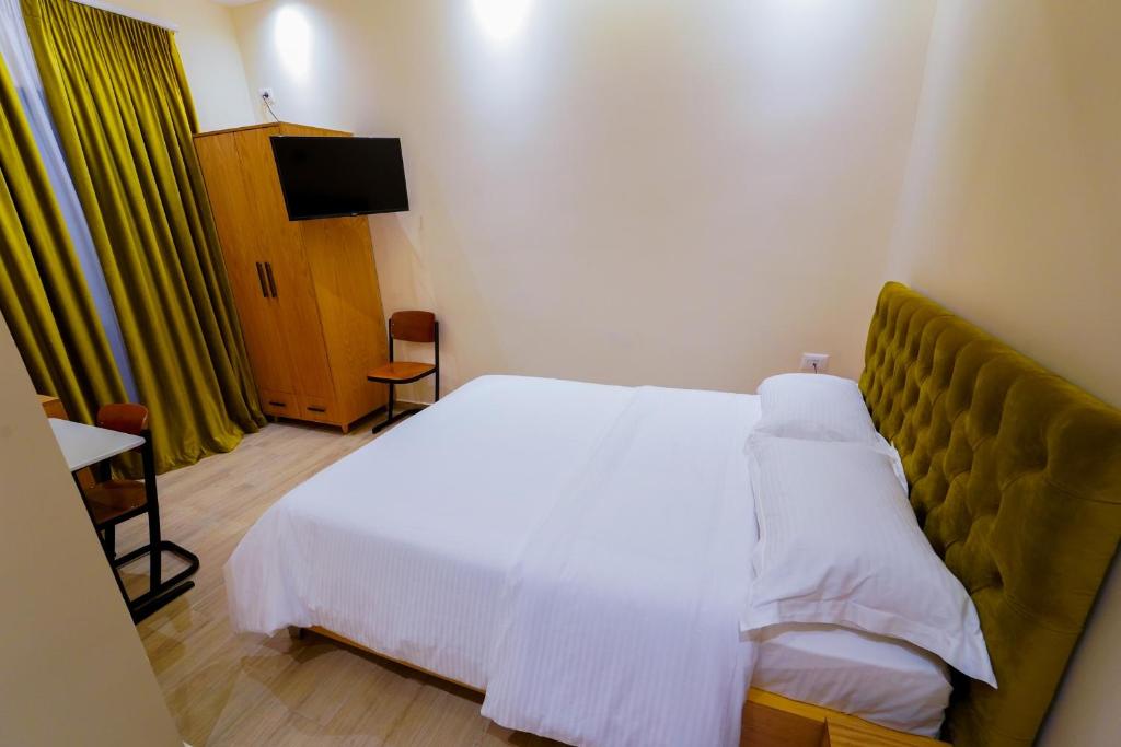 Postel nebo postele na pokoji v ubytování SR99 Hotel