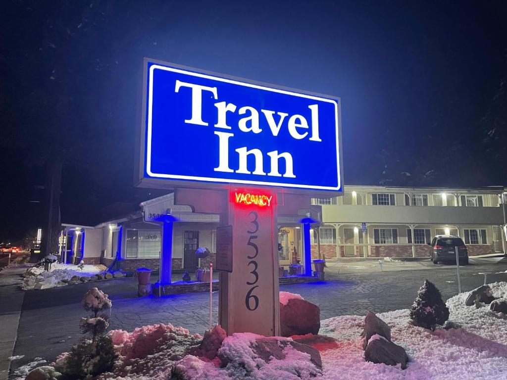a sign for a travel inn in the snow at Travel Inn in South Lake Tahoe
