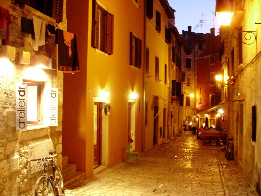 an alley in an old town at night at Apartment Casa Nova in Rovinj