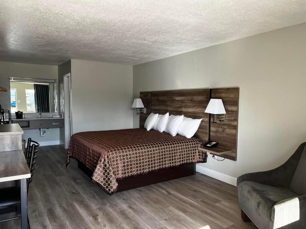 une chambre d'hôtel avec un lit et un canapé dans l'établissement Regency Inn, à Gatesville