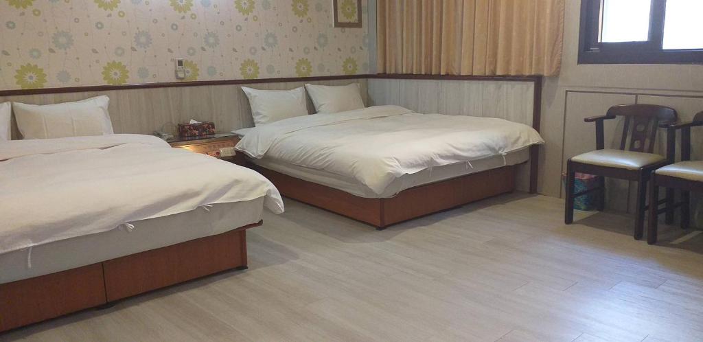 Postel nebo postele na pokoji v ubytování Jin Ge hot spring Hotel