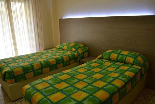 Кровать или кровати в номере Hotel Rosa Del Tirreno