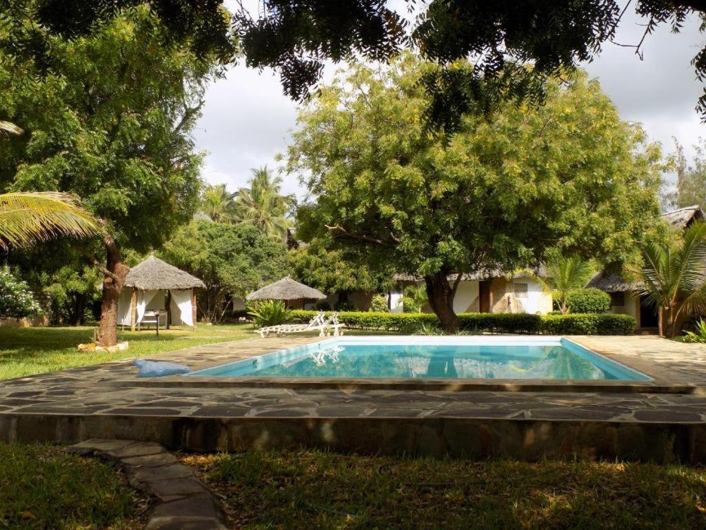 a swimming pool in the yard of a house at Watamu Eco Villas in Watamu