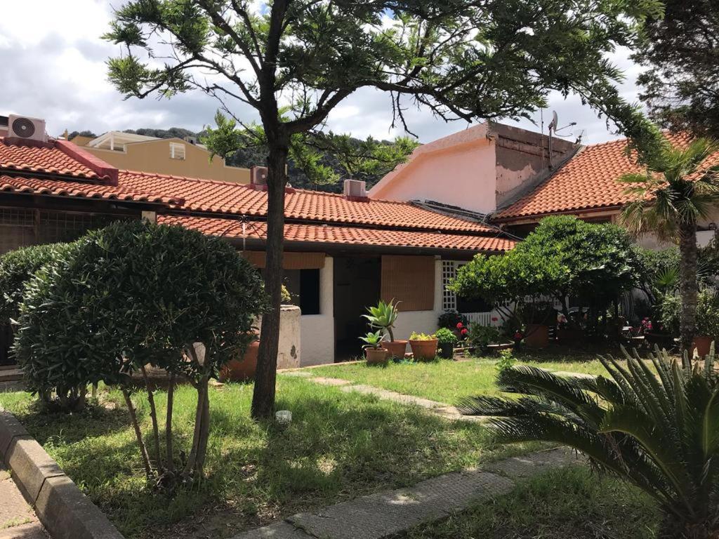 a house with a yard with grass and trees at LA CASA DI MARTA in Milazzo