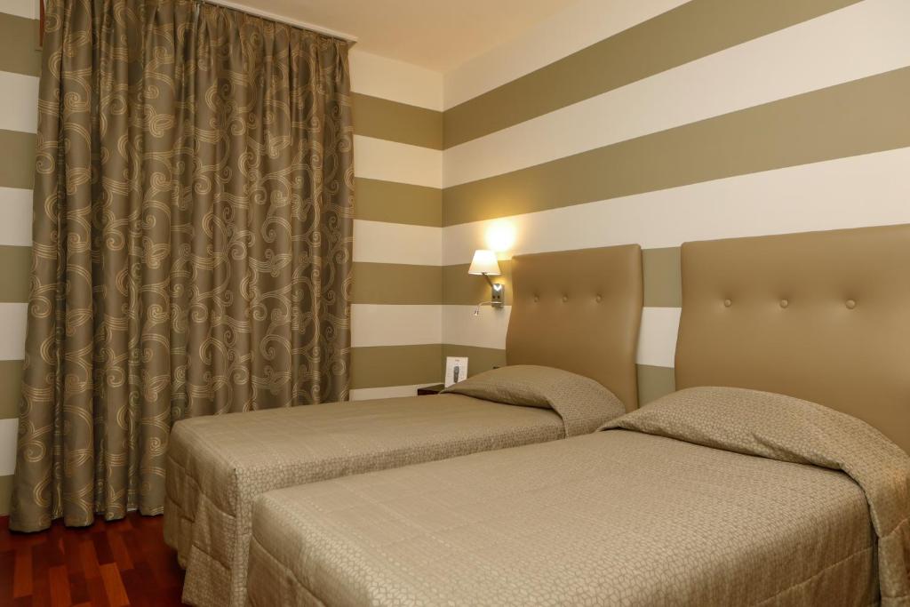 Posteľ alebo postele v izbe v ubytovaní Hotel Lancaster