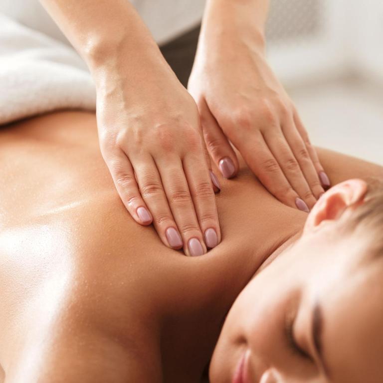 a woman getting a massage from a therapist at Spa Resort Luxury Apartments in Budva