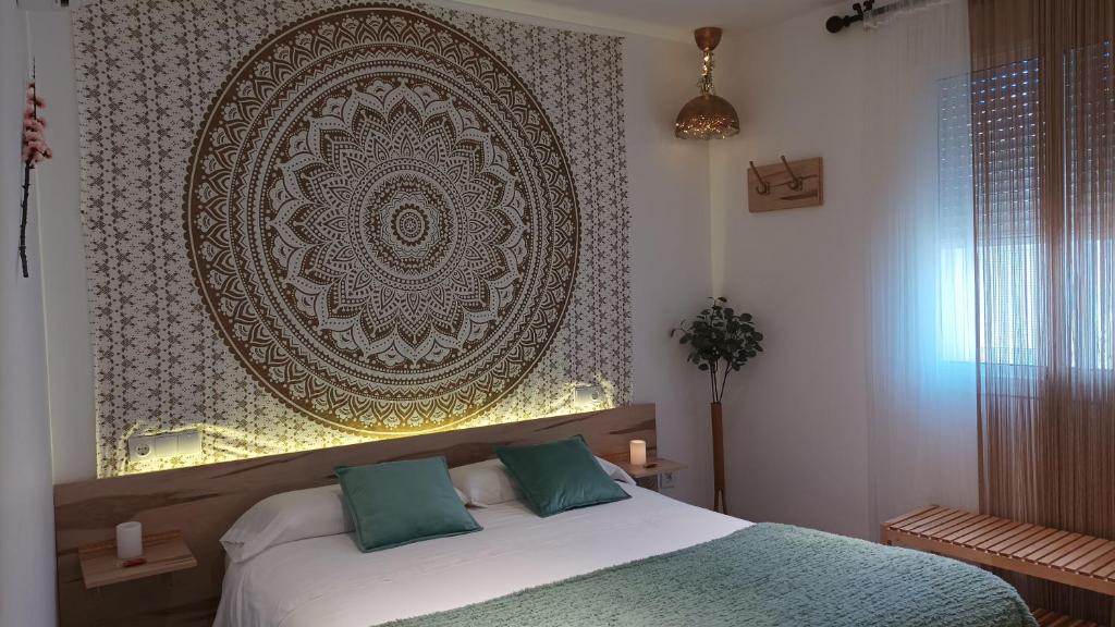 a bedroom with a bed and a large wall art at El Duende del Tejar in El Gastor