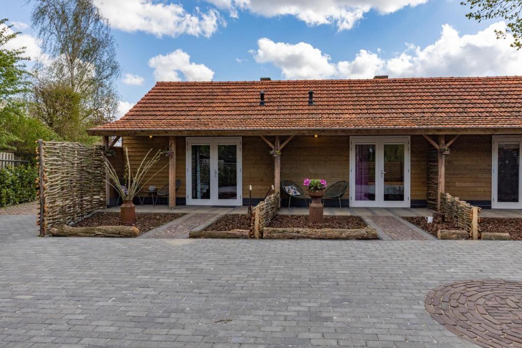 a house with a tile roof at Bed and Breakfast Klein Beek in Hilvarenbeek