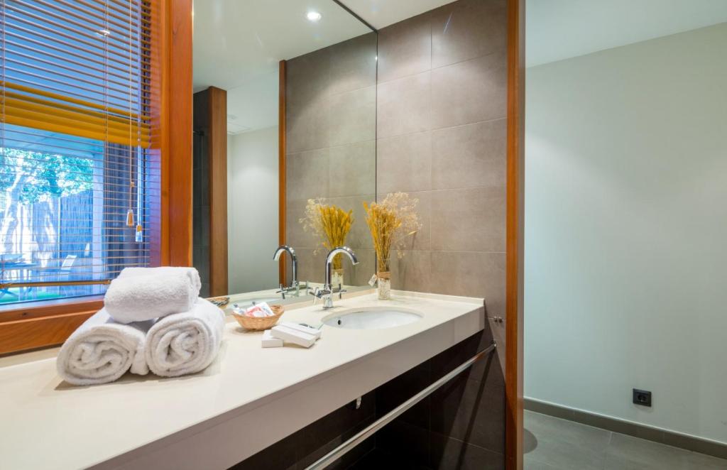 a bathroom with a sink and a mirror at Mas Ses Vinyes - Adults Only in Begur