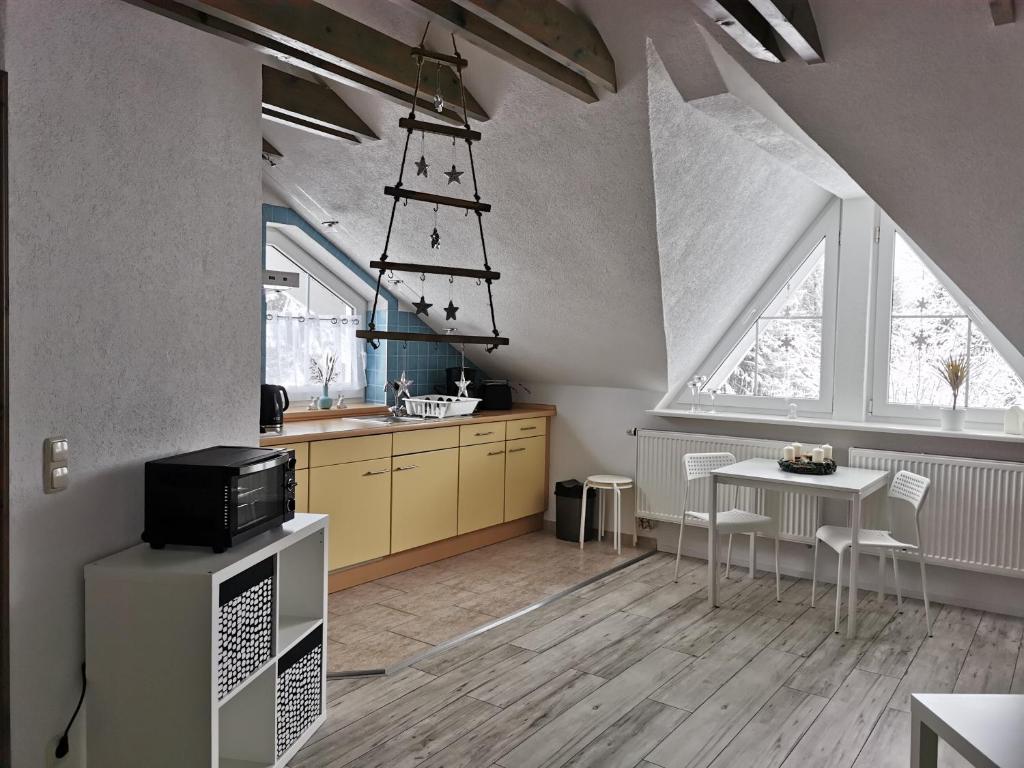 a kitchen with a sink and a table at Ferienwohnung "Am Wald" in Schmiedefeld am Rennsteig