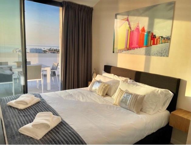 a bedroom with a large bed with a large window at The View Luxury Vacation Penthouse 1 in Fuengirola