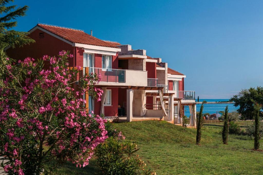 a house with a view of the ocean at Apartments Katoro Plava Laguna in Umag