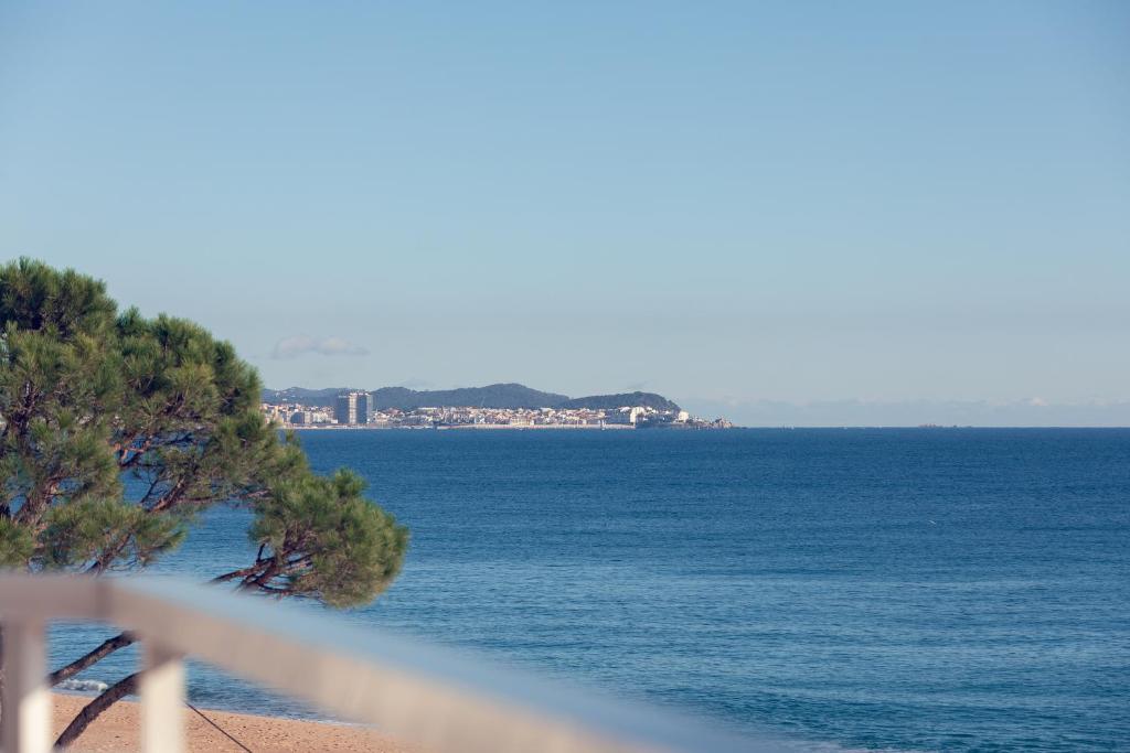 a view of the ocean from a balcony at Hauzify I Apartament Cannes in Platja d'Aro