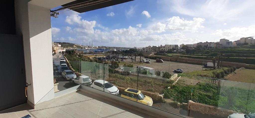 a balcony with a view of a parking lot at Sayonara in Marsaxlokk