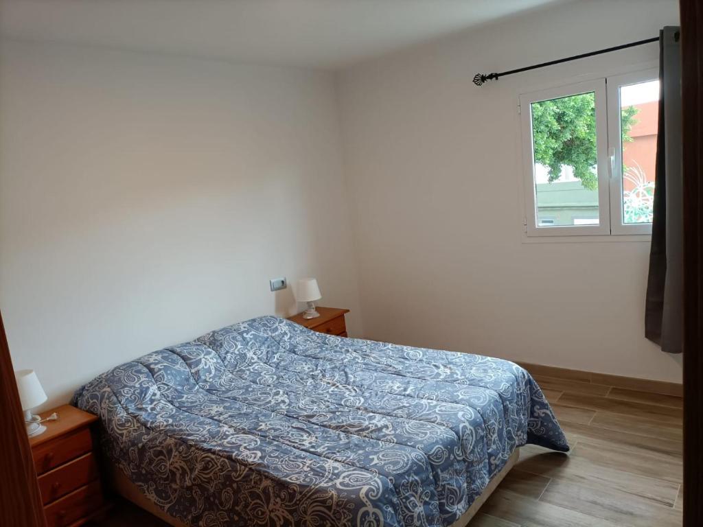 a bedroom with a bed and a window at Apartment Taliarte 36 in Vecindario