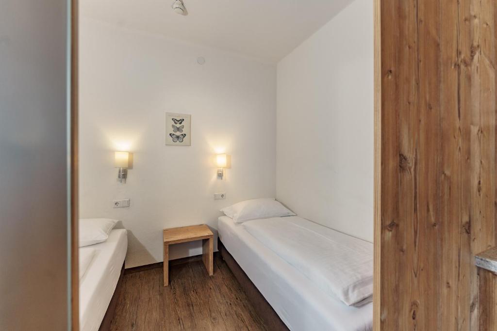 A bed or beds in a room at Appartements Landhaus Hubertus Wellness & Breakfast