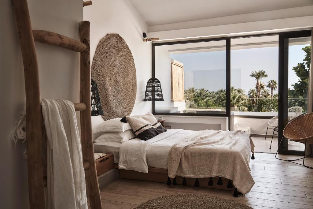 a bedroom with a bed and a large window at Casa Cabana Boutique Hotel & Spa - Adults Only in Faliraki