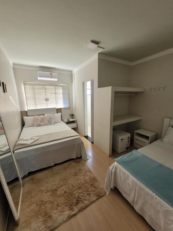 Postel nebo postele na pokoji v ubytování Hotel Hiperion Maringá