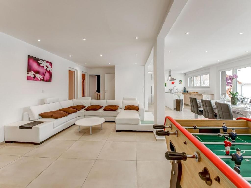 a living room with a couch and a pool table at Beautiful cottage in La Chaux with jacuzzi in La Chaux