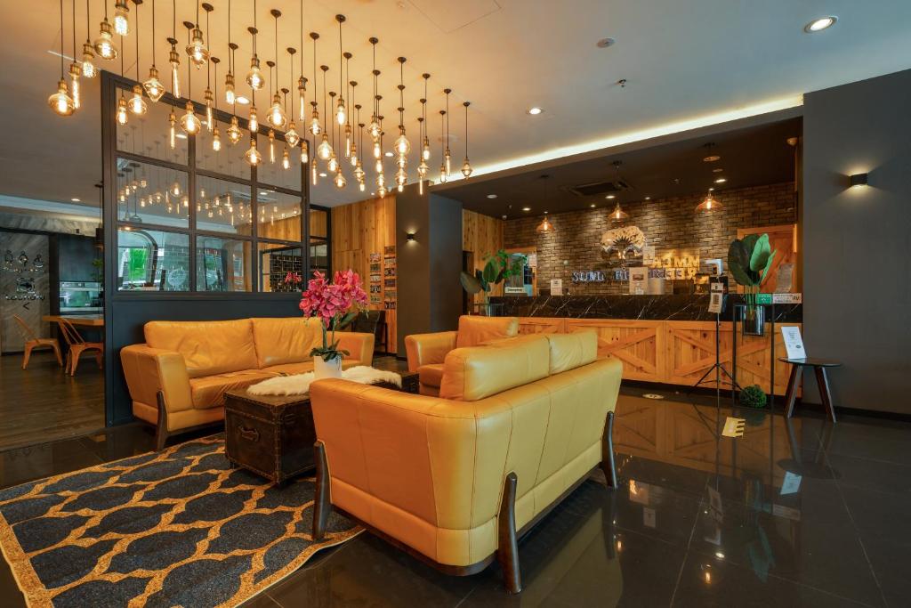 a lobby with two couches and a bar at Summer Tree Hotel Penang in George Town