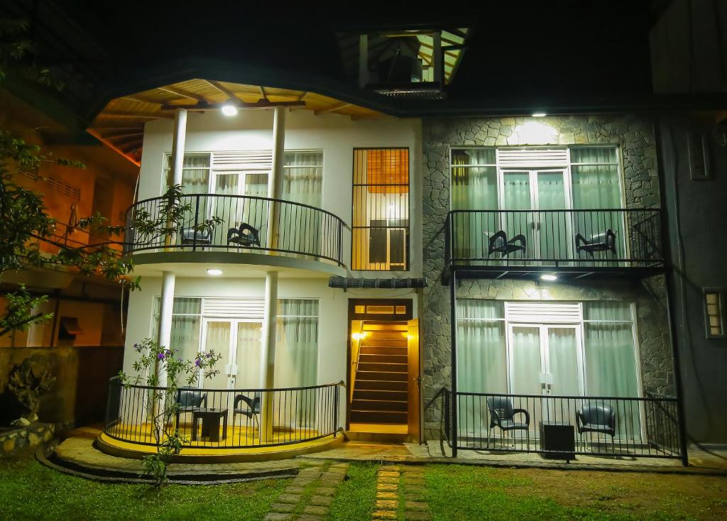 a building with two balconies on it at night at Ella moon rock in Ella