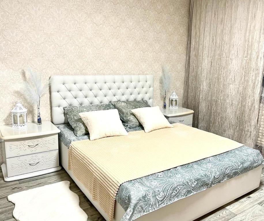 a bedroom with a large bed and a white dresser at 1-комнатная Квартира Взлётная 51 in Barnaul