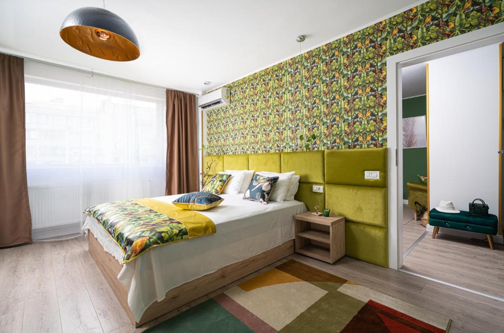 um quarto com uma cama e uma parede verde em Amazon - DeLuxe One Bedroom em Bucareste