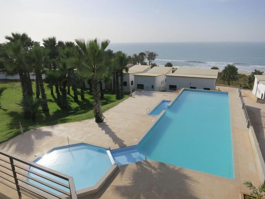 an overhead view of a swimming pool with the ocean at Silafando apartment - ecofriendly oceanview in Bijilo