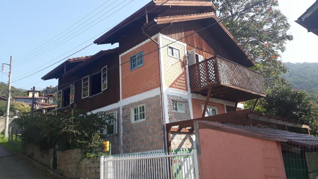 a house with a balcony on the side of it at Casa da Lagoa in Florianópolis