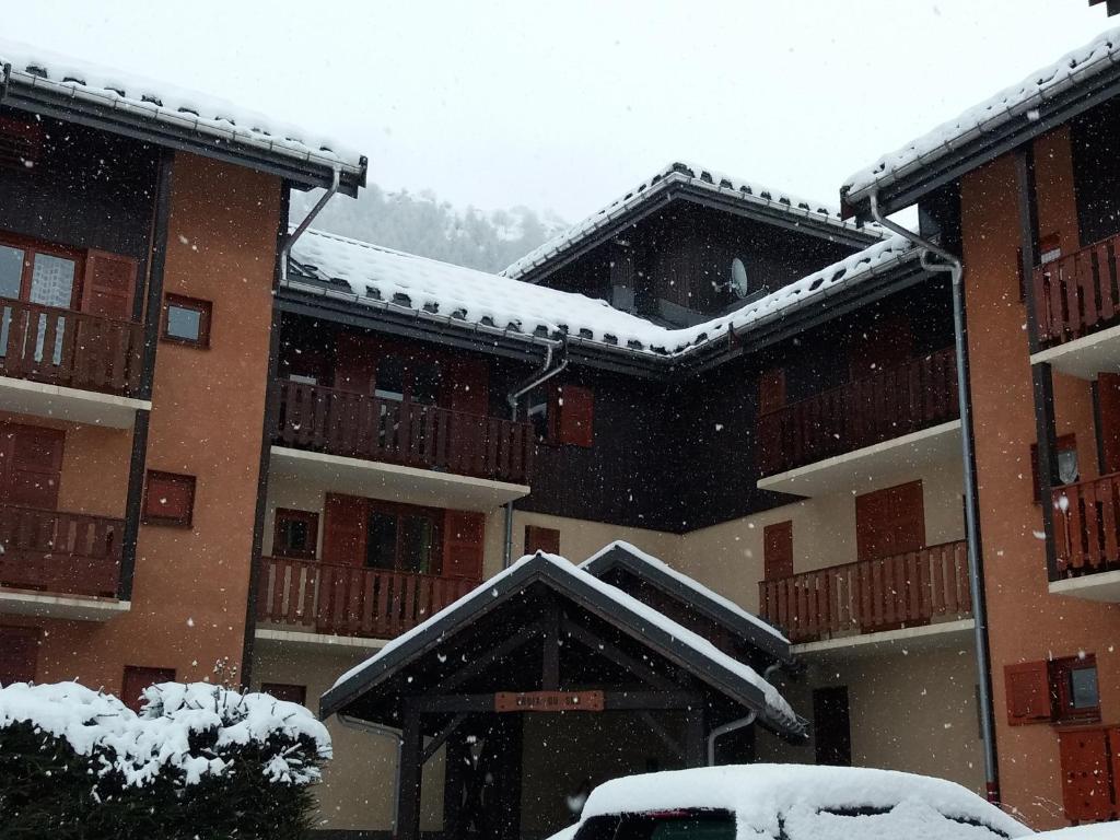 a snow storm in front of a building at Valloire Studio Marmotte : Nid douillet centre de valloire, été / hiver 4p in Valloire
