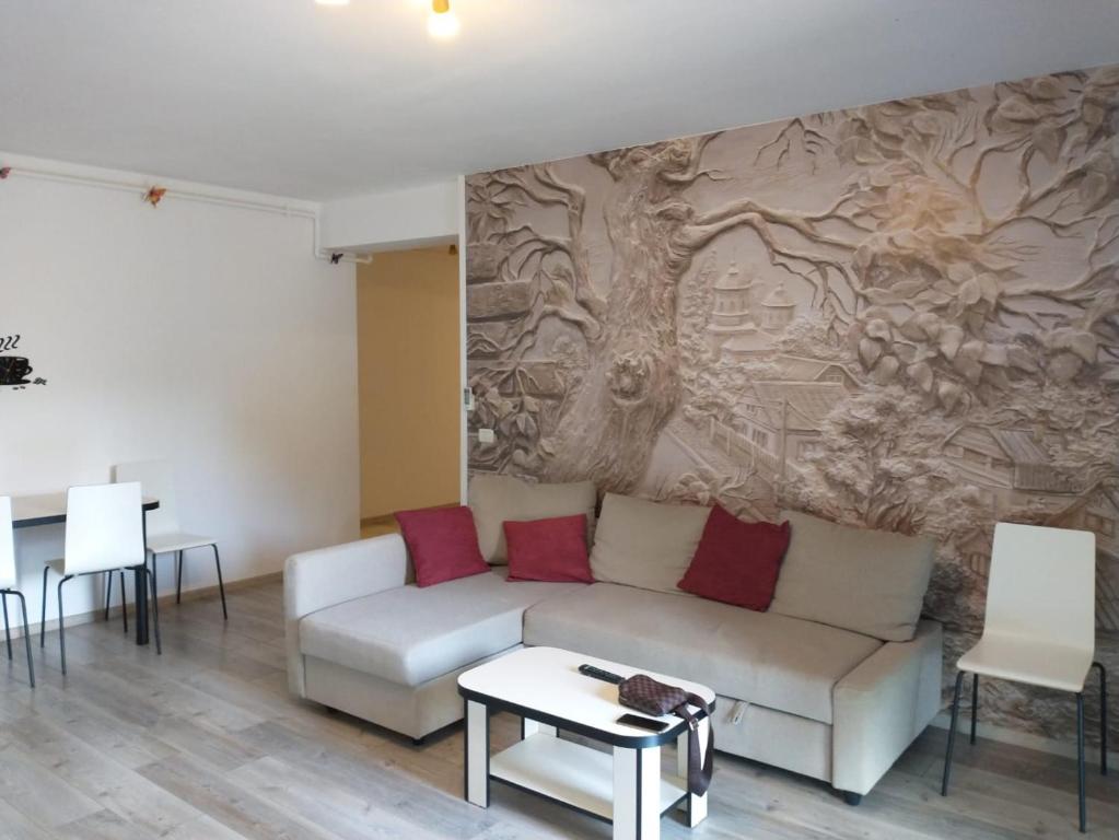 a living room with a couch and a wall at Apartament in complex rezidential cu parcare. in Timişoara