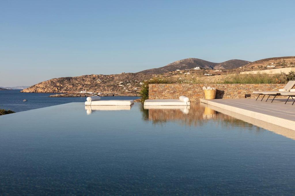 a swimming pool with a view of the water at NOS Hotel & Villas in Sifnos