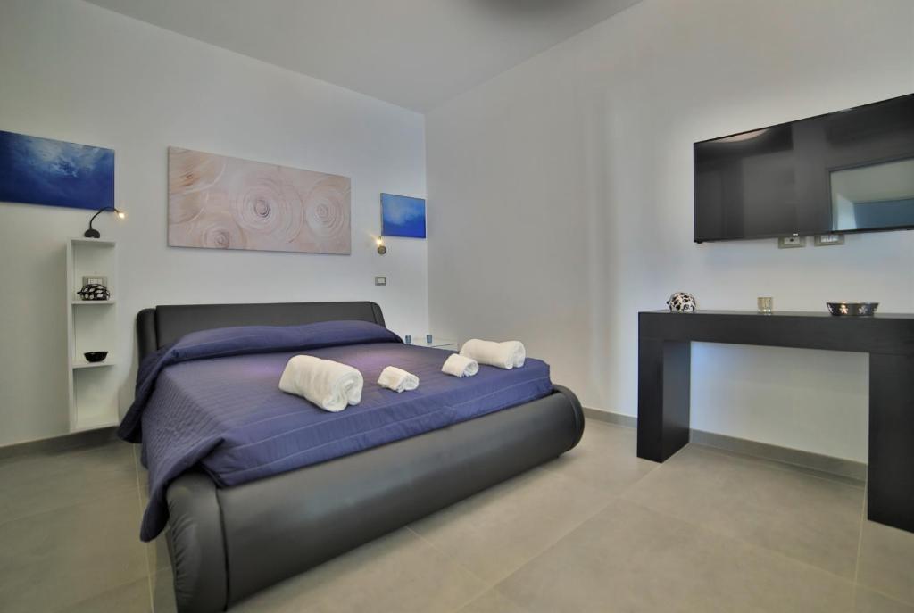 een slaapkamer met een bed met 2 kussens erop bij Residence il Caicco in Porto Cesareo