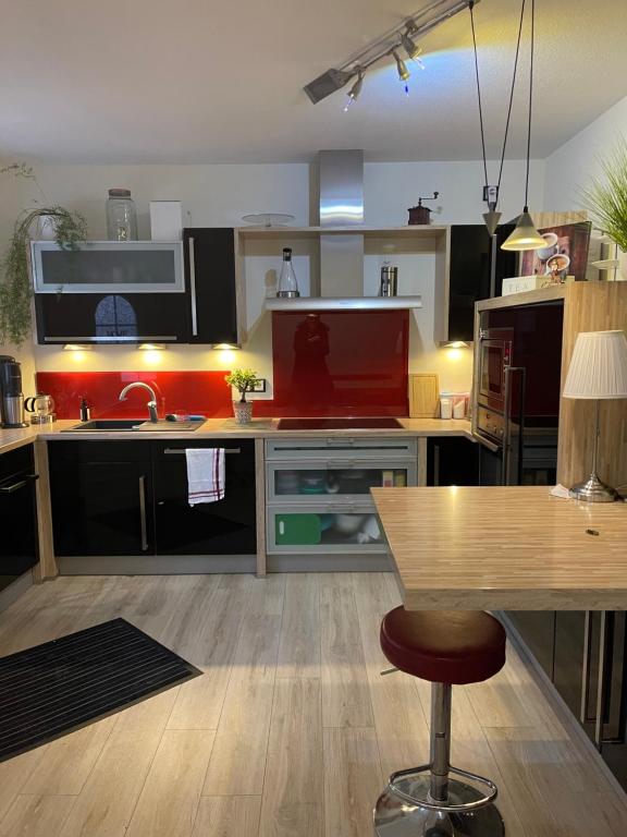 a large kitchen with a wooden table and a counter top at Zur Sonnenterrasse in Hemer