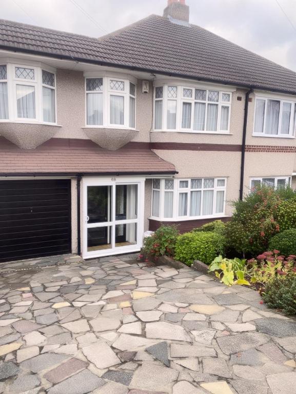 a house with a stone driveway in front of it at Bexleyhealth Town Center 5 Bedroom Luxurious Home in Bexleyheath