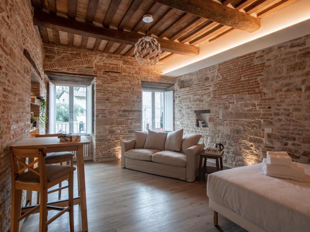 a living room with a brick wall at Residenza Donna Iohanna in Gubbio