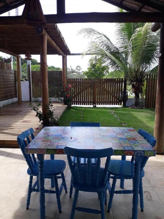 a table and chairs on a patio at Chalé Sunset Taipu de Fora in Marau