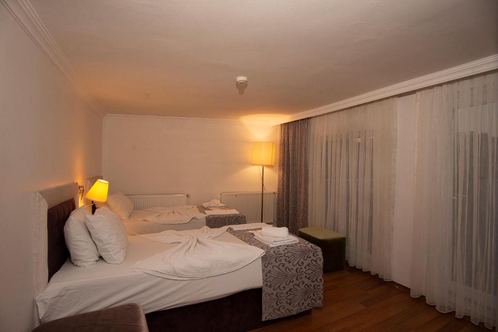 Postel nebo postele na pokoji v ubytování SRF Hotel