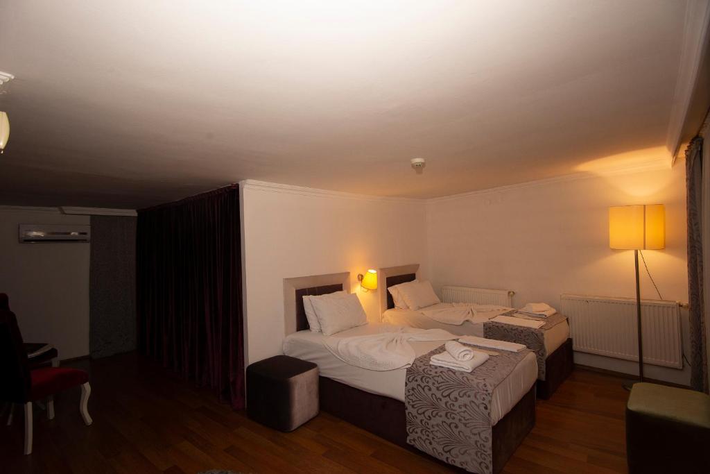 Postel nebo postele na pokoji v ubytování SRF Hotel