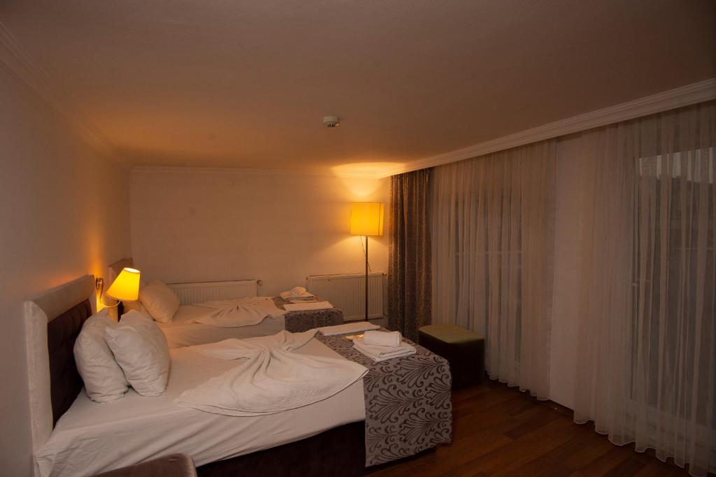 Postel nebo postele na pokoji v ubytování SRF Hotel