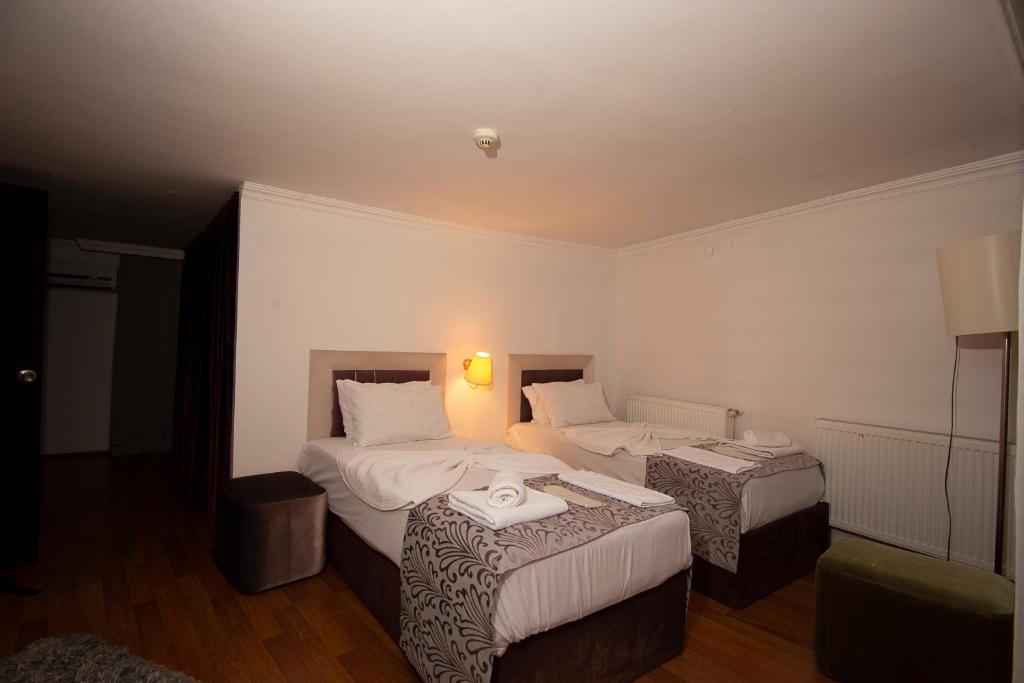 Postel nebo postele na pokoji v ubytování SRF Hotel