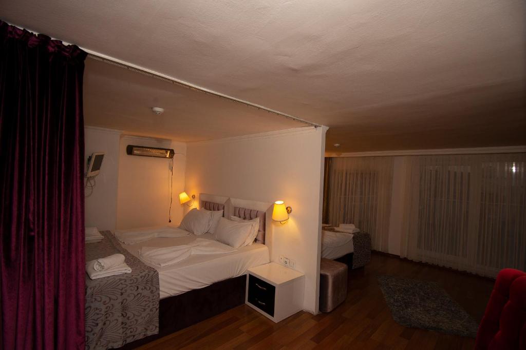 Postel nebo postele na pokoji v ubytování SRF Hotel