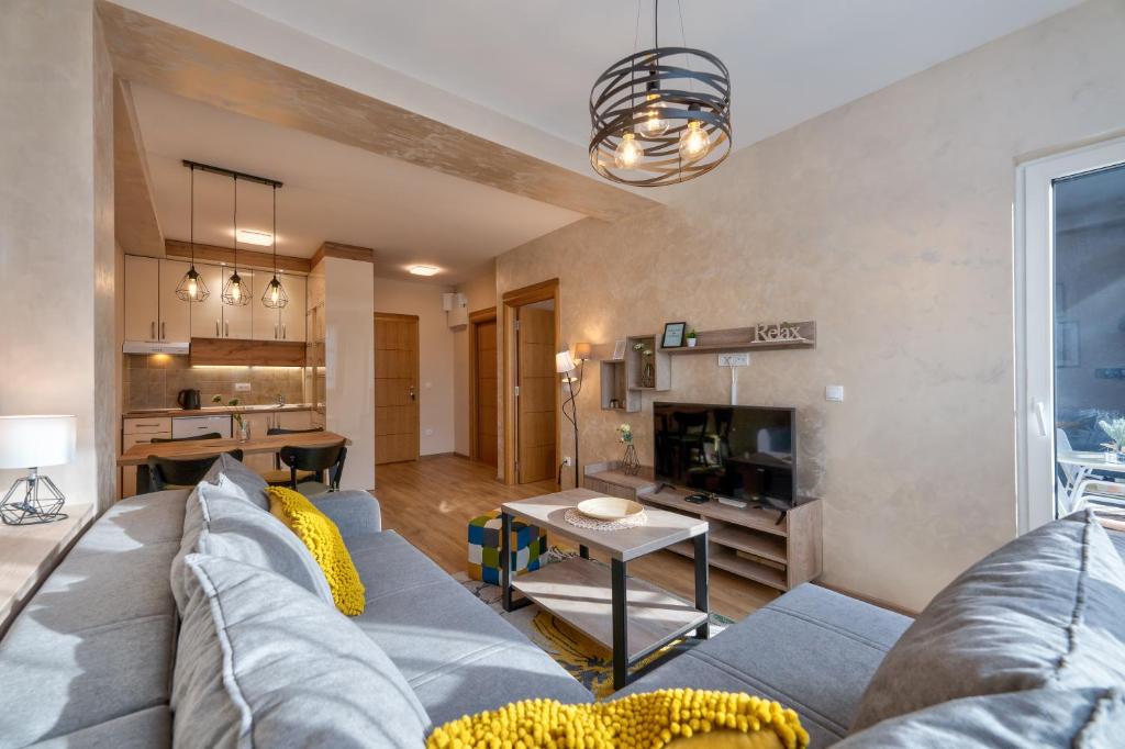 a living room with a couch and a table at Bella Gondola Zlatibor in Zlatibor