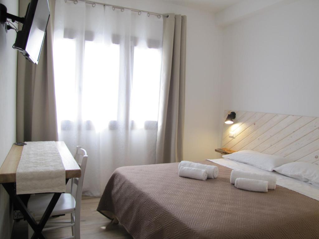 A bed or beds in a room at Affittacamere Su Maistu e Linna