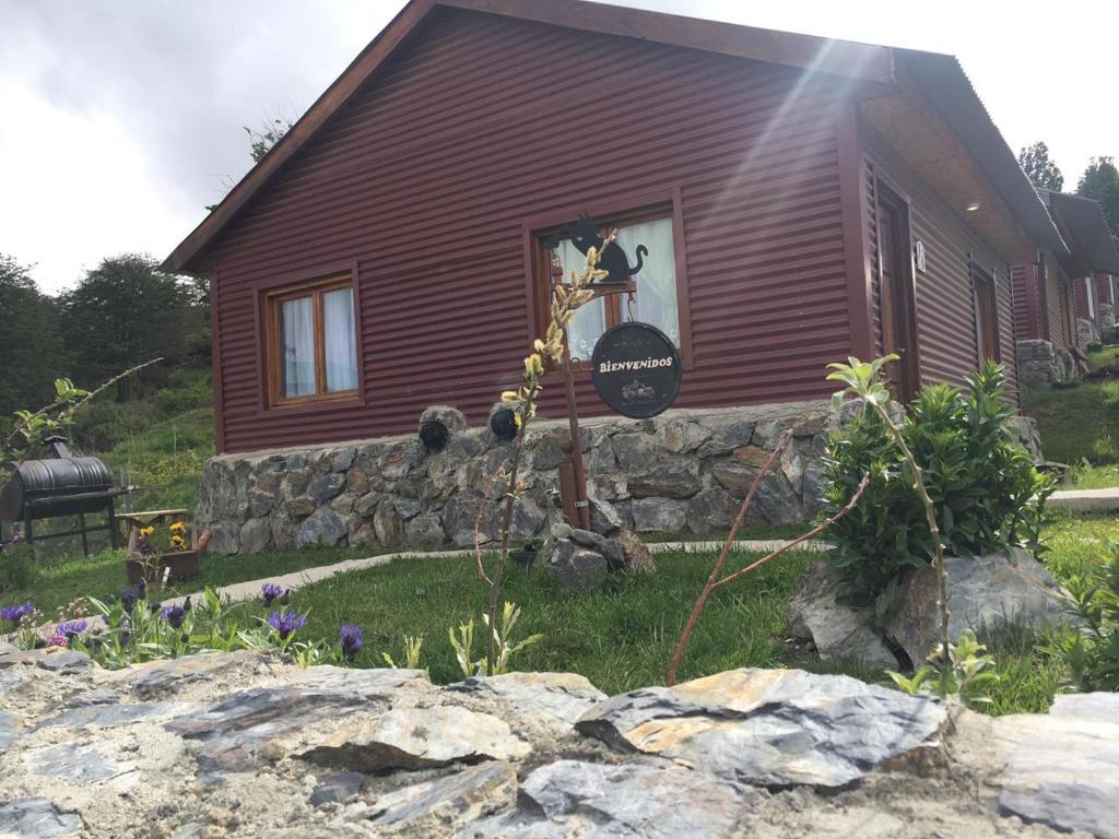 a house with a sign in the window of it at Cabañas "Las Margaritas" in Ushuaia