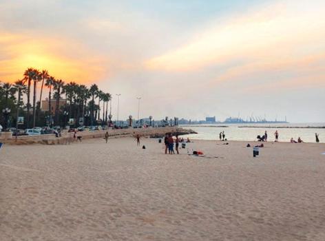 a group of people on a beach at sunset at RosAmar in Bari