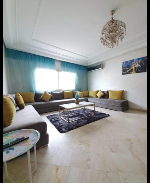 a living room with a couch and a table at Résidence jnane California in Casablanca