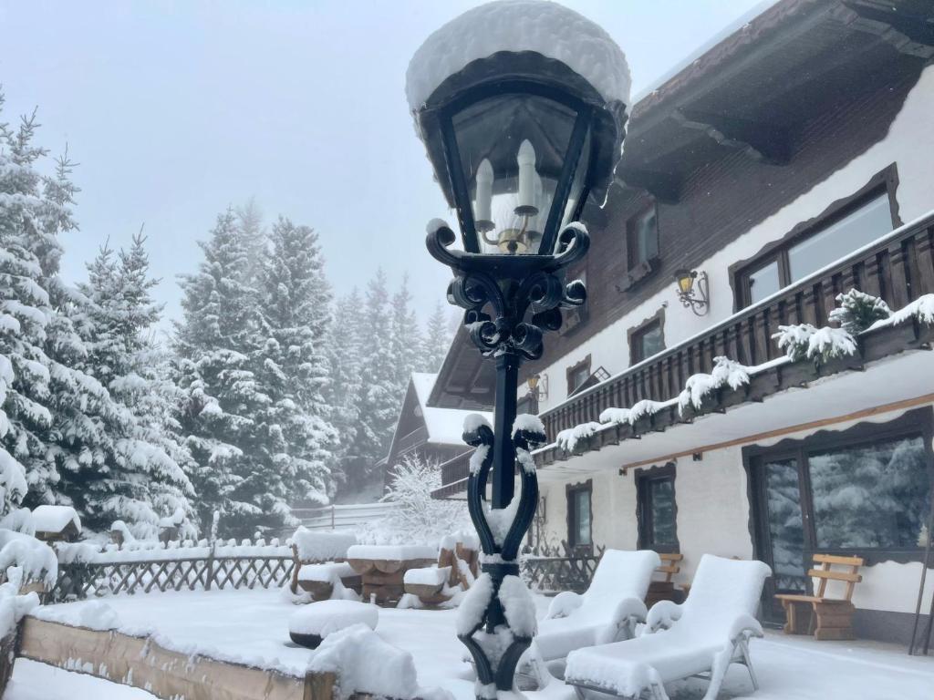 a street light covered in snow in front of a house at Almhaus-Klippitz in Klippitztorl